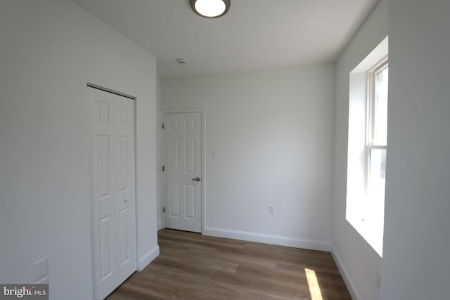 2420 N Reese St, Philadelphia, PA 19133 - unfurnished bedroom featuring multiple windows, a closet, and wood finished floors
