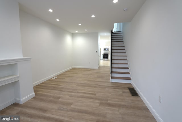 2420 N Reese St, Philadelphia, PA 19133 - below grade area with recessed lighting, stairs, and light wood-style flooring