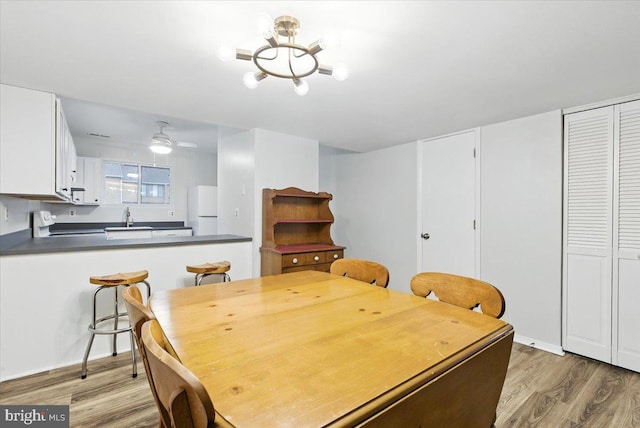 1348 Hazel Nut Ct, Annapolis, MD 21409 - dining area with light wood-style floors and a chandelier