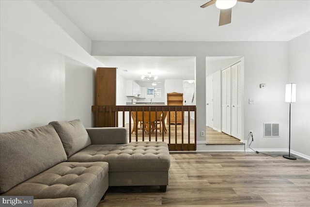 1348 Hazel Nut Ct, Annapolis, MD 21409 - living area featuring wood finished floors, ceiling fan, and a chandelier