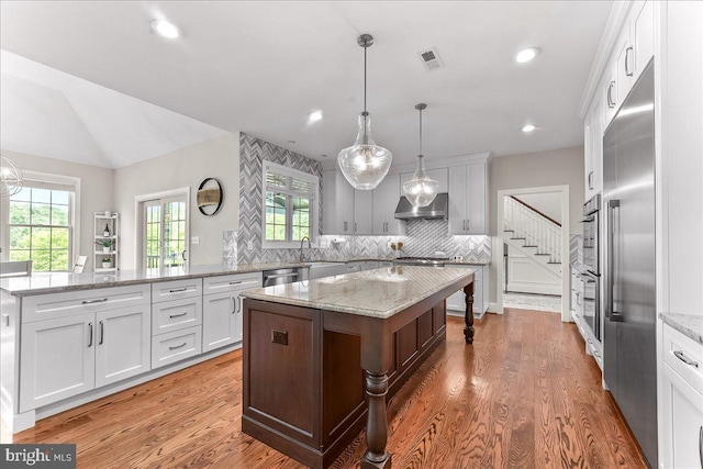 203 Geist View Cir, Media, PA 19063 - kitchen featuring exhaust hood, a center island, stainless steel appliances, decorative backsplash, and white cabinetry