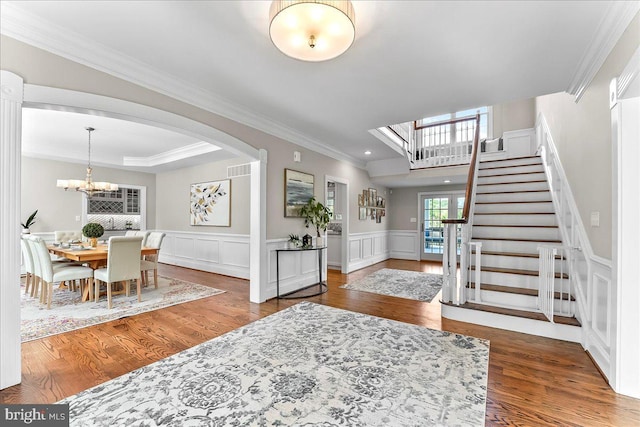 203 Geist View Cir, Media, PA 19063 - foyer featuring wood finished floors, stairway, a chandelier, crown molding, and arched walkways