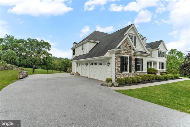 203 Geist View Cir, Media, PA 19063 - view of front of house with stone siding, asphalt driveway, a chimney, and a front lawn