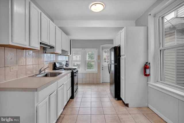 521 Bergen St, Gloucester City, NJ 08030 - kitchen featuring black appliances, white cabinetry, and light tile patterned floors