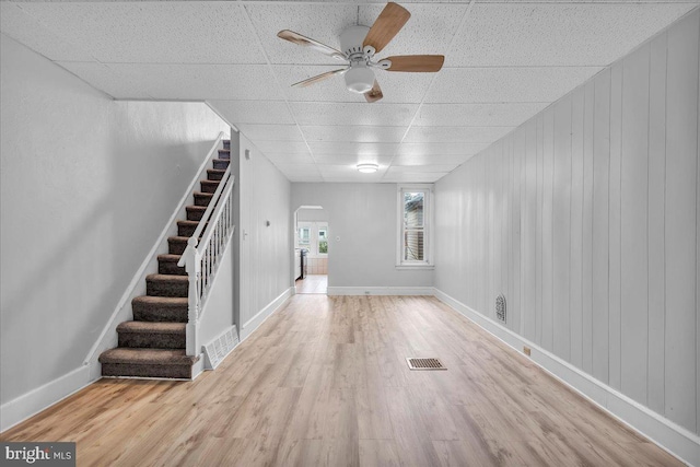 521 Bergen St, Gloucester City, NJ 08030 - unfurnished living room with a drop ceiling, wood finished floors, ceiling fan, arched walkways, and stairs