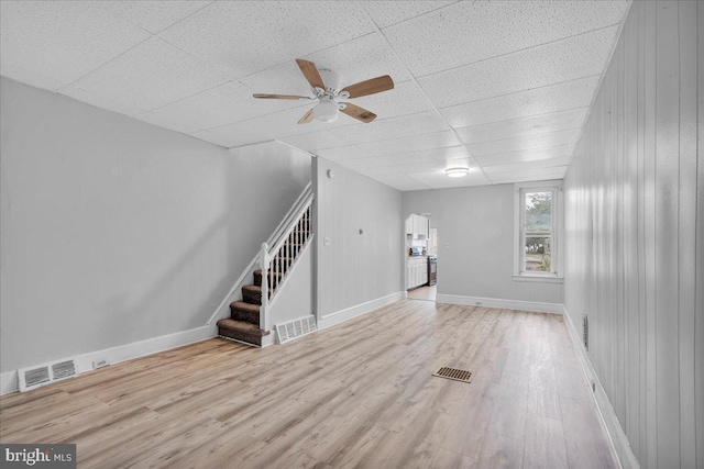 521 Bergen St, Gloucester City, NJ 08030 - unfurnished living room featuring a ceiling fan, wood finished floors, stairs, and a drop ceiling