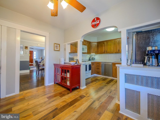 121 Wayne Ave, Springfield, PA 19064 - kitchen with white appliances, light countertops, light wood-type flooring, a ceiling fan, and tasteful backsplash