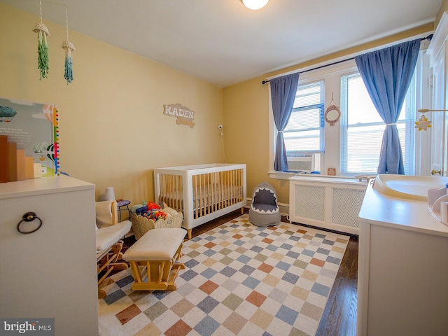 121 Wayne Ave, Springfield, PA 19064 - bedroom featuring radiator heating unit, a nursery area, and cooling unit