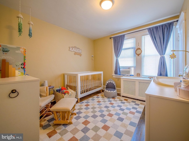 121 Wayne Ave, Springfield, PA 19064 - bedroom with radiator, a crib, and cooling unit