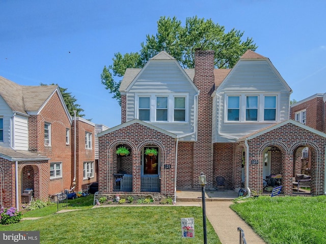 121 Wayne Ave, Springfield, PA 19064 - view of front of home featuring a front yard, brick siding, and a chimney
