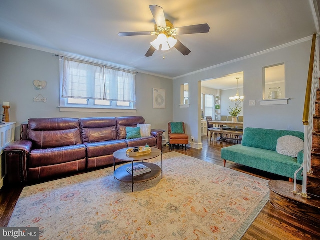 121 Wayne Ave, Springfield, PA 19064 - living room featuring wood finished floors, healthy amount of natural light, a ceiling fan, crown molding, and a chandelier