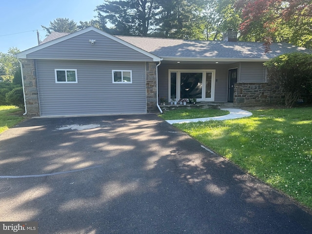 1409 Clements Rd, Wyncote, PA 19095 - view of front of house with stone siding, a chimney, a front yard, and driveway