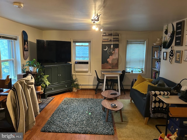 1220 Pine St, Philadelphia, PA 19107 - living room featuring plenty of natural light, cooling unit, wood finished floors, and a baseboard heating unit