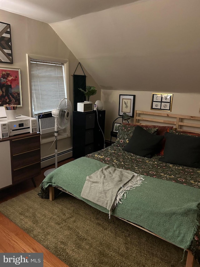 1220 Pine St, Philadelphia, PA 19107 - bedroom featuring a baseboard heating unit, wood finished floors, vaulted ceiling, and cooling unit