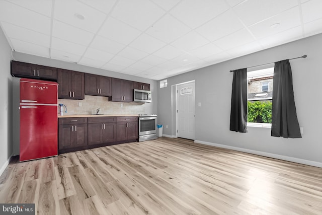 3706 Garrett Rd, Drexel Hill, PA 19026 - kitchen with appliances with stainless steel finishes, a paneled ceiling, light countertops, light wood finished floors, and dark brown cabinetry