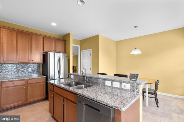 43559 Wheadon Ter, Chantilly, VA 20152 - kitchen with appliances with stainless steel finishes, brown cabinets, decorative light fixtures, light tile patterned floors, and recessed lighting