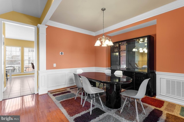 43559 Wheadon Ter, Chantilly, VA 20152 - dining area with a chandelier, wood-type flooring, wainscoting, crown molding, and decorative columns