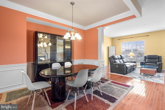 43559 Wheadon Ter, Chantilly, VA 20152 - dining area with a chandelier, hardwood / wood-style flooring, a wainscoted wall, decorative columns, and crown molding