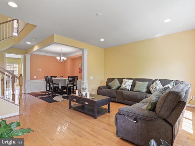 43559 Wheadon Ter, Chantilly, VA 20152 - living area with ornate columns, stairway, light wood finished floors, a wainscoted wall, and a decorative wall