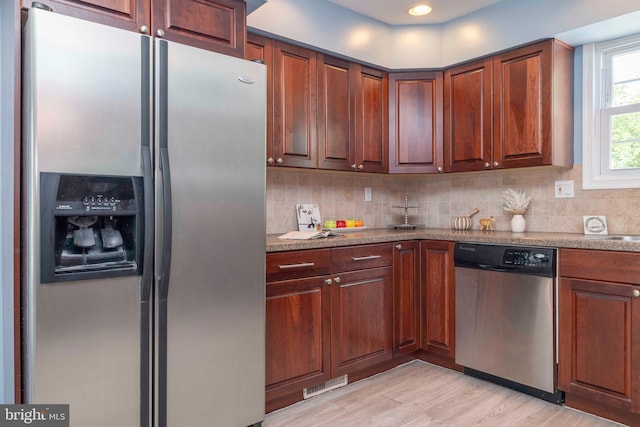 3112 Victoria Ct, Bensalem, PA 19020 - kitchen featuring stainless steel appliances, backsplash, light wood-style floors, and light stone counters