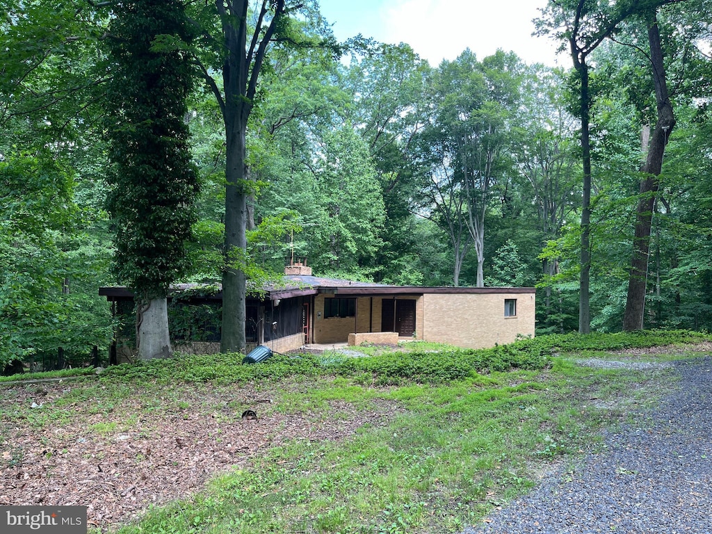 4871 Ellicott Woods Ln, Ellicott City, MD 21043 - view of front of property featuring a chimney and a forest view