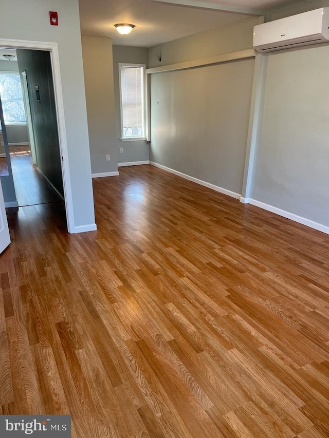 3637 N 19th St, Philadelphia, PA 19140 - unfurnished room with a wall unit AC, wood finished floors, and plenty of natural light