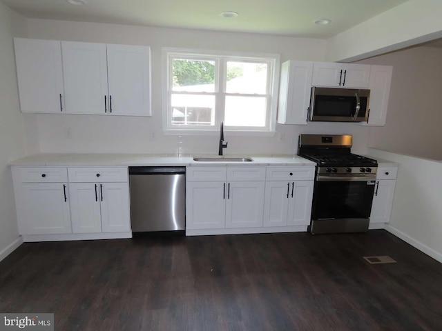 32 Stevens Ave, New Castle, DE 19720 - kitchen with appliances with stainless steel finishes, white cabinets, dark wood finished floors, and recessed lighting