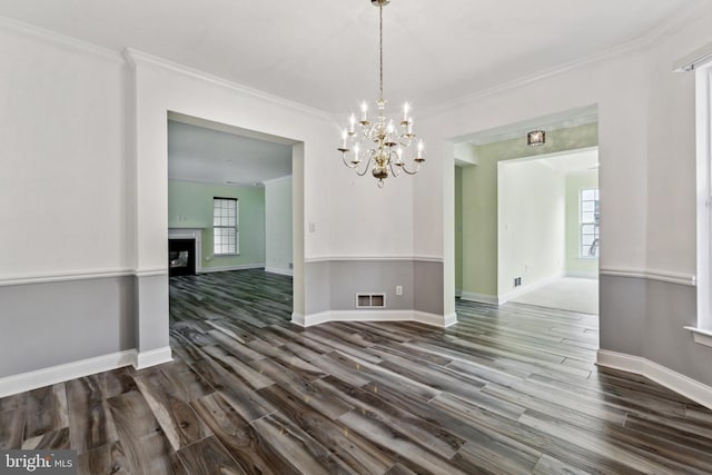 343 Daylilly Way, Middletown, DE 19709 - unfurnished dining area featuring dark wood finished floors, a chandelier, a fireplace, and ornamental molding