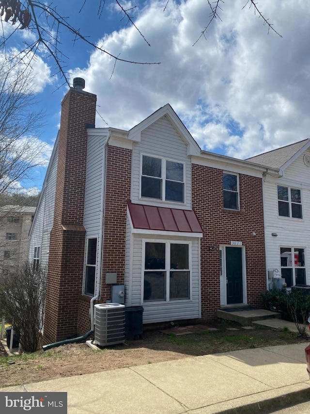 3621 Pogonia Ct Unit 3A, Hyattsville, MD 20784 - view of front of property with a standing seam roof, a chimney, brick siding, and a metal roof