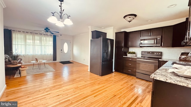 2323 Flag Marsh, Mount Airy, MD 21771 - kitchen featuring stainless steel appliances, light wood finished floors, backsplash, dark brown cabinetry, and crown molding