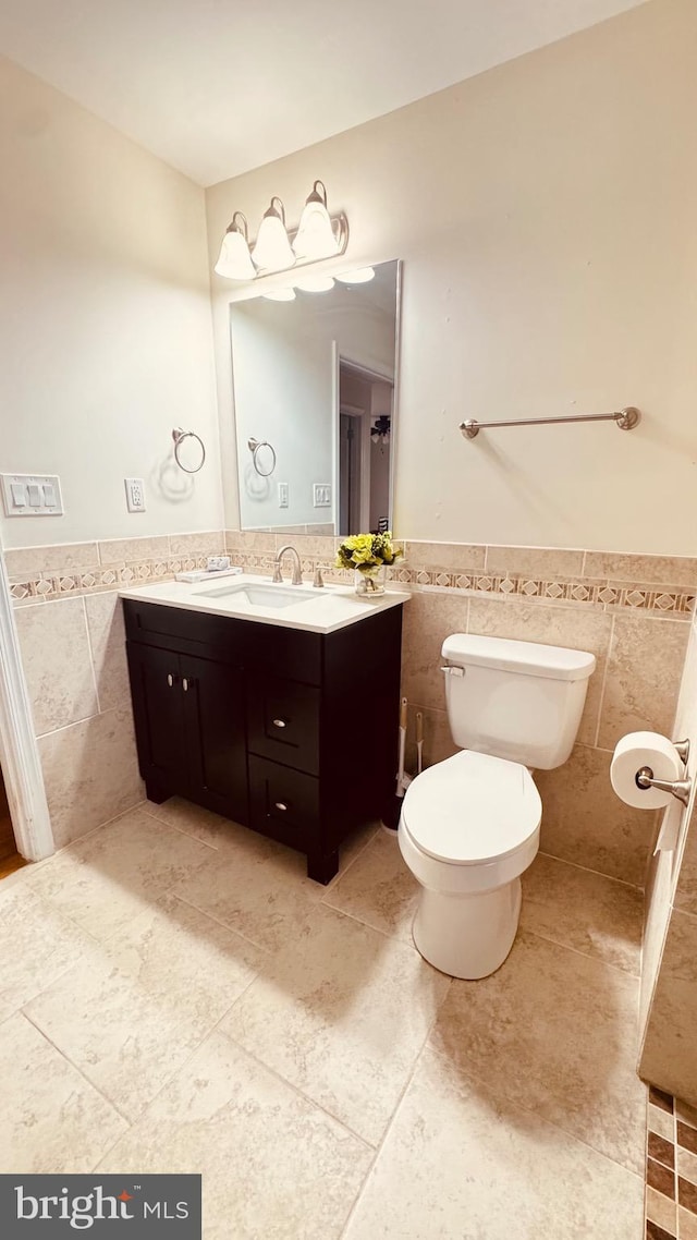 2323 Flag Marsh, Mount Airy, MD 21771 - bathroom featuring tile walls, vanity, a wainscoted wall, and tile patterned flooring