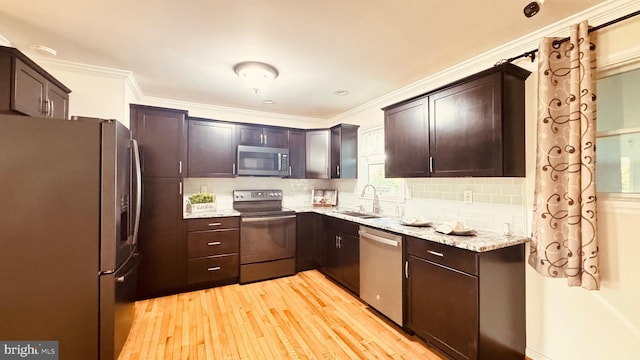 2323 Flag Marsh, Mount Airy, MD 21771 - kitchen with stainless steel appliances, light wood-style floors, ornamental molding, dark brown cabinetry, and tasteful backsplash