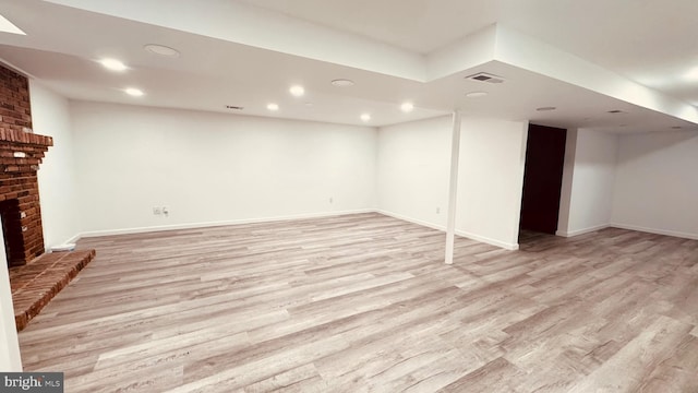 2323 Flag Marsh, Mount Airy, MD 21771 - finished below grade area featuring light wood-style floors, a brick fireplace, and recessed lighting