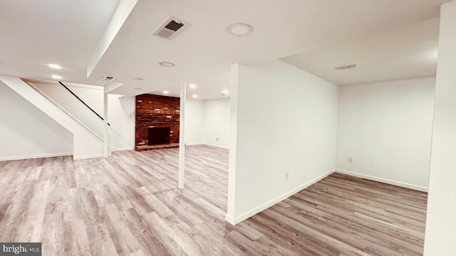 2323 Flag Marsh, Mount Airy, MD 21771 - unfurnished living room with wood finished floors, a brick fireplace, stairs, and recessed lighting
