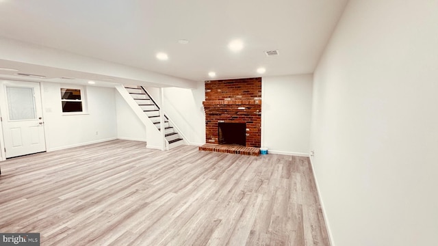 2323 Flag Marsh, Mount Airy, MD 21771 - unfurnished living room featuring light wood-style floors, stairs, a fireplace, and recessed lighting