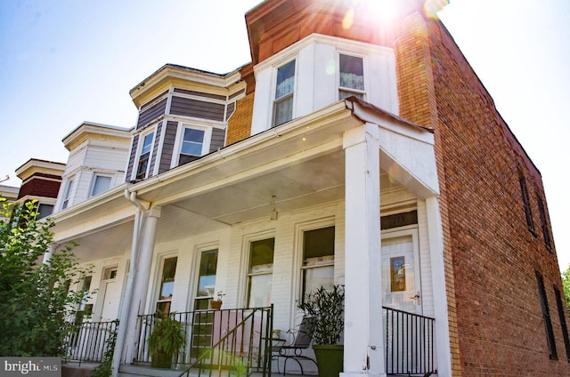 713 E 23rd St, Baltimore, MD 21218 - view of front facade featuring covered porch