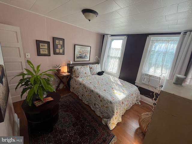 713 E 23rd St, Baltimore, MD 21218 - bedroom featuring wood finished floors and cooling unit