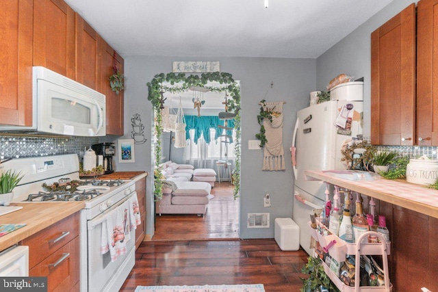 4433 Forest View Ave, Baltimore, MD 21206 - kitchen featuring white appliances, brown cabinetry, wooden counters, and backsplash