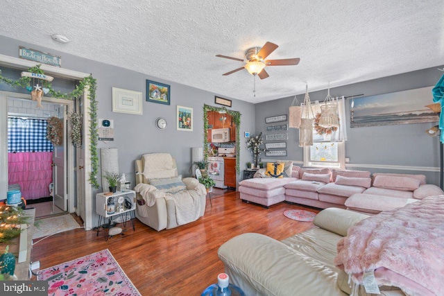 4433 Forest View Ave, Baltimore, MD 21206 - living area with ceiling fan, wood finished floors, and a textured ceiling