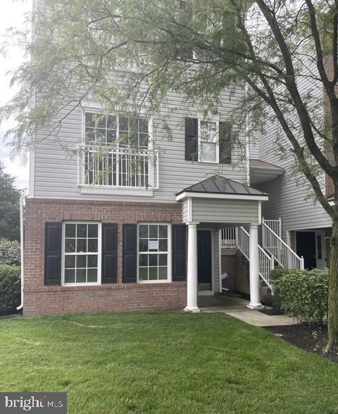 302 Lisa, Cinnaminson, NJ 08077 - back of property featuring brick siding, a yard, stairs, a standing seam roof, and a metal roof