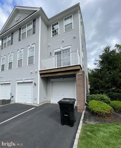 302 Lisa, Cinnaminson, NJ 08077 - view of front of home with a garage, driveway, and a balcony
