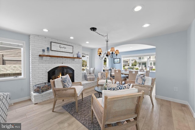 44 Harbor Ln, Long Beach Township, NJ 08008 - living area featuring a fireplace, light wood-type flooring, a chandelier, arched walkways, and recessed lighting