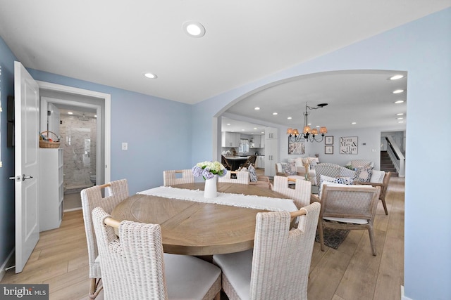 44 Harbor Ln, Long Beach Township, NJ 08008 - dining area with arched walkways, a chandelier, light wood-style floors, recessed lighting, and stairs