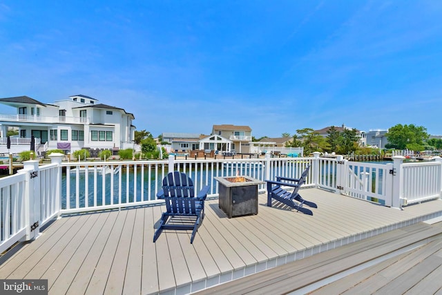 44 Harbor Ln, Long Beach Township, NJ 08008 - deck featuring an outdoor fire pit, a residential view, and a water view