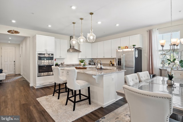 12606 Rosencrans Dr, Hagerstown, MD 21740 - kitchen featuring stainless steel appliances, an island with sink, wall chimney range hood, white cabinetry, and dark wood-style flooring