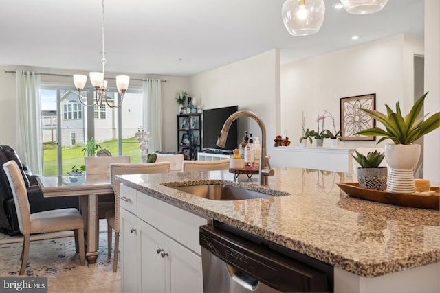 12606 Rosencrans Dr, Hagerstown, MD 21740 - kitchen with stainless steel dishwasher, a chandelier, light stone counters, white cabinetry, and pendant lighting