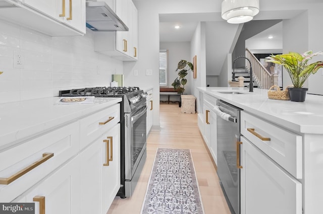 3708 Fairview Ave, Baltimore, MD 21216 - kitchen featuring range hood, stainless steel appliances, light countertops, white cabinetry, and recessed lighting