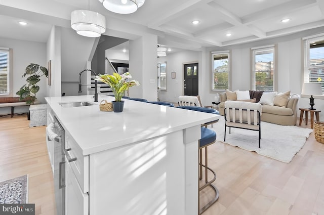 3708 Fairview Ave, Baltimore, MD 21216 - kitchen featuring coffered ceiling, white cabinetry, recessed lighting, light wood-style flooring, and a kitchen island with sink