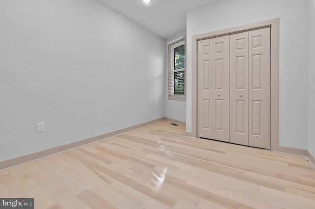 3708 Fairview Ave, Baltimore, MD 21216 - unfurnished bedroom featuring light wood-style floors, a closet, lofted ceiling, and recessed lighting