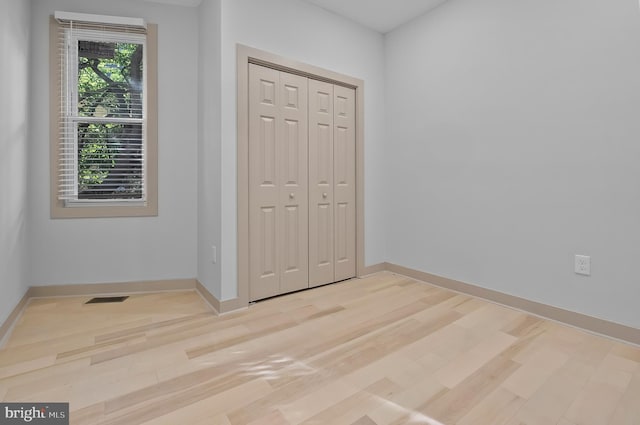 3708 Fairview Ave, Baltimore, MD 21216 - unfurnished bedroom with light wood finished floors and a closet